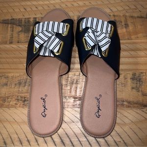 Black slide sandals with gold accents